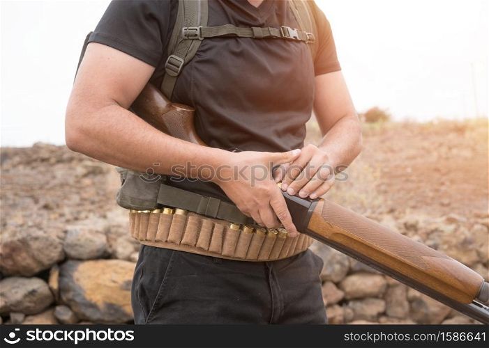 Close up view of an unrecognizable hunter with a shotgun. High quality photo. Close up view of an unrecognizable hunter with a shotgun.