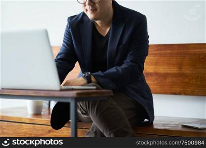 Close up view of businessman using laptop .