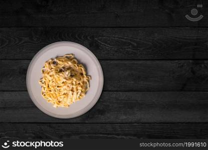 Close up view of chicken fried egg slices isolated on black wooden table.