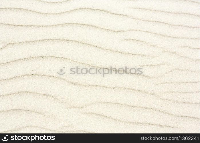 Close up view of color stripes made by water waves. Sand stripes texture background. Summer vacation, holiday at sea concept.