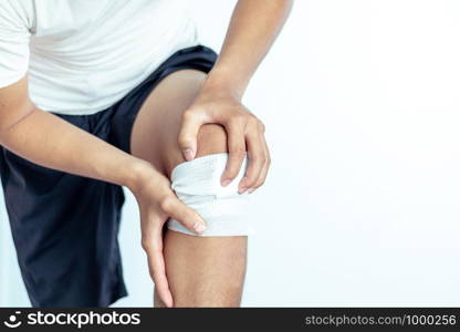 Close-up view of Cotton bandage over a wound on knee, accidents concept photo.