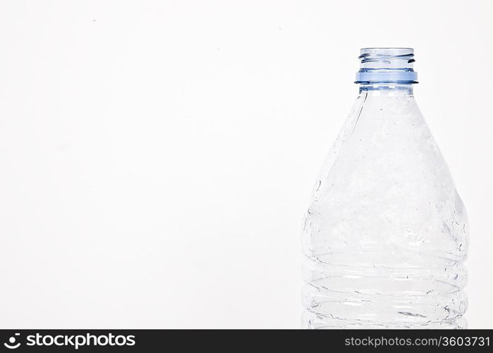 Close-up view of empty plastic bottle over white background