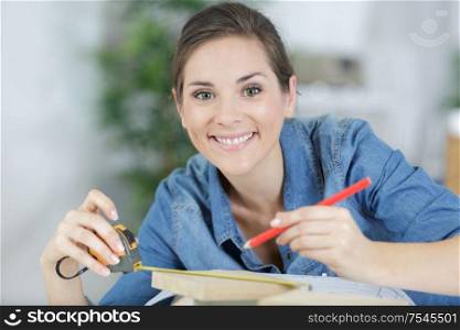 close up view of hardworking woman holding ruler and pencil