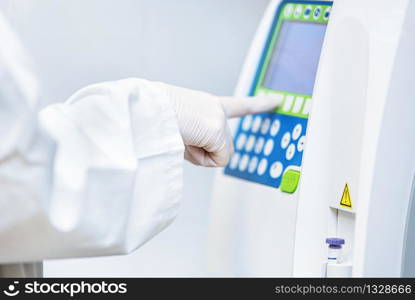 Close up view of laboratory equipment. Blood contaminated by Coronavirus and a sample of it being analyzed .. Close up view of laboratory equipment. Blood contaminated by Coronavirus and a sample of it being analyzed.