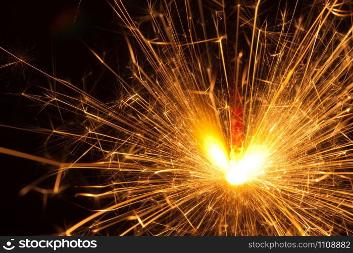 Close-up view of lit up holiday sparkler