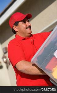 Close-up view of middle-aged delivery man unloading containers