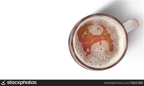 Close up view of mug beer with bubble on glass isolated on white background. top view. celebration concept.