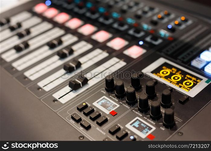 Close up view of multichannel digital audio mixing console. Selective focus.