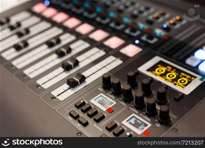 Close up view of multichannel digital audio mixing console. Selective focus.