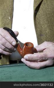 Close-up view of owner holding tobacco pipe