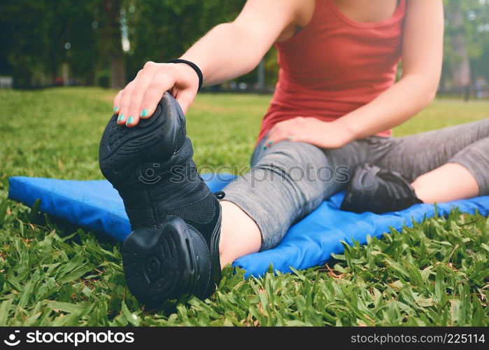Close up view of sport woman streching legs. Outdoors