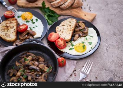 Close up view of the fried egg, mushrooms and bread on a frying pan.. Close up view of the fried egg, mushrooms and bread on a frying pan