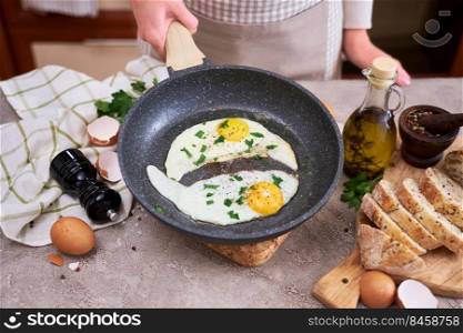 Close up view of the fried egg on a frying pan.. Close up view of the fried egg on a frying pan