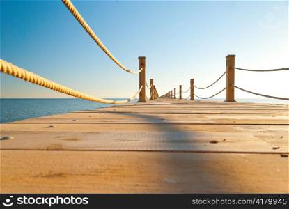 close up view of tropical wooden pier at sunny weather, clear skies