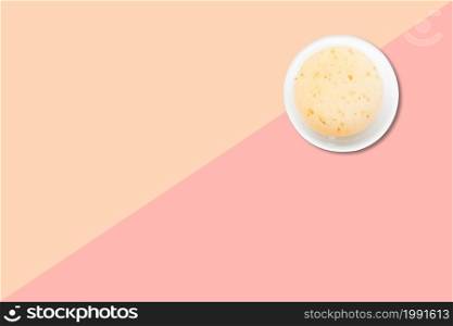 Close up view of wheat porridge isolated on pink background.