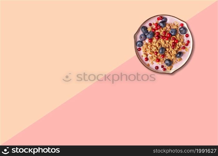 Close up view of wheat porridge with blueberry isolated on pink background.