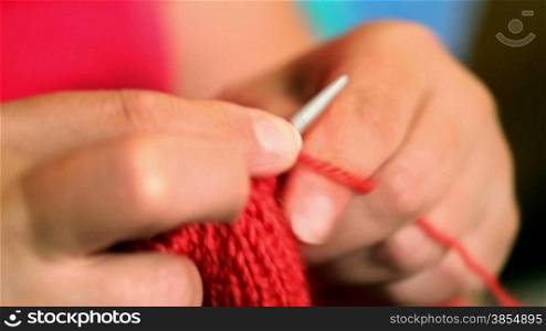 Close-up view of woman hands doing knitting