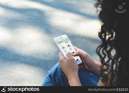 Close up view of woman shopping for clothes on smartphone. E-commerce concept. All screen graphics are made up by us