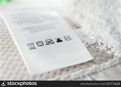 Close up view on an washing label tag and washing powder.