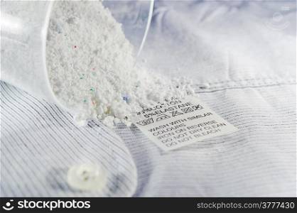 Close up view on an washing label tag and washing powder.