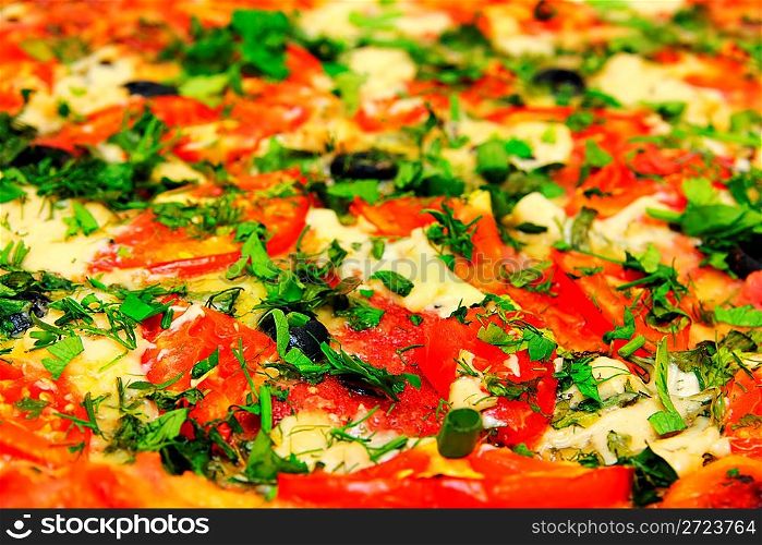 close-up view on pizza with tomatoes and greens