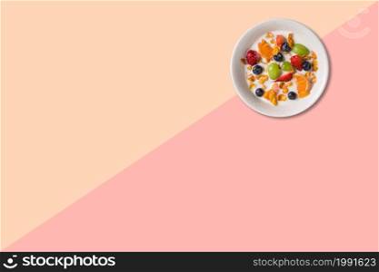 Close up view various fruits soup with milk isolated on pink background.