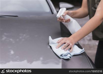 close up view with woman cleaning car