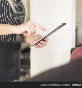 close up waitress using digital tablet