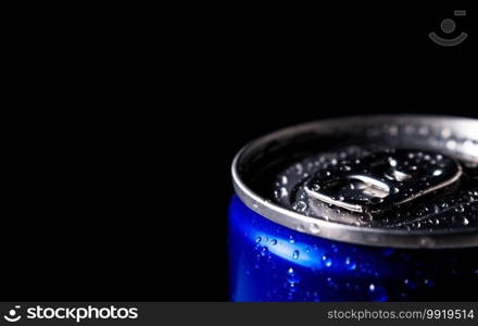 Close up water drop on lid of blue soft drink can and black background