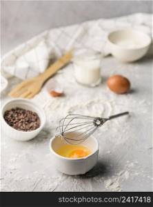 close up whisk with egg baking flour table
