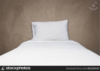 Close up white bedding and pillow on gray concrete texture background