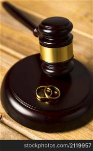close up with judge gavel stand with wedding rings