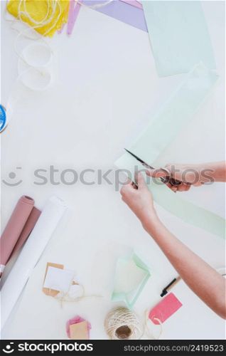 close up woman cutting card paper with scissor