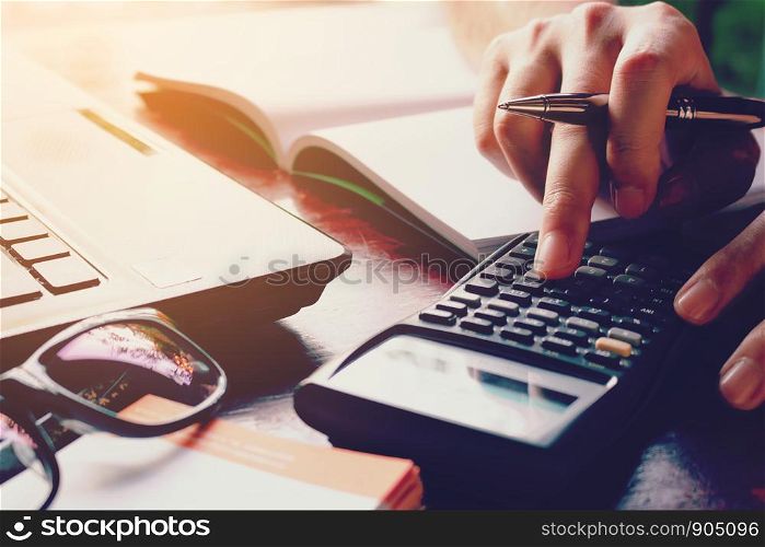 Close up woman doing finance at home office with calculate expenses.