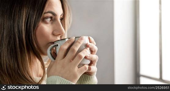 close up woman drinking from cup