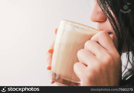 Close up woman drinking hot latte coffee at cafe