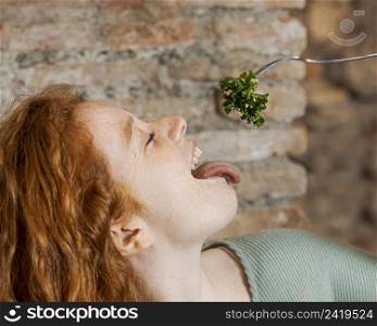 close up woman eating vegetable