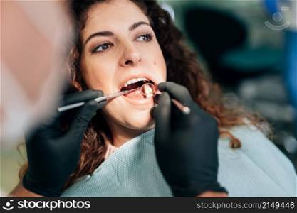 close up woman getting check up dentist