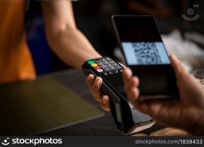 Close up woman hand holding using smartphone while making contactless payment at cafe,Mobile payment.