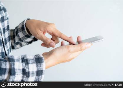 close up woman hand using smartphone on white background. Finger of woman touch screen on mobile phone.