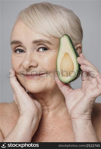 close up woman holding avocado