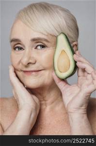 close up woman holding avocado