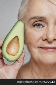 close up woman holding avocado 3