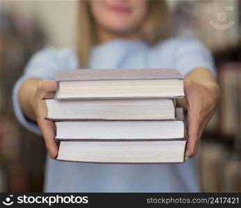 close up woman holding books