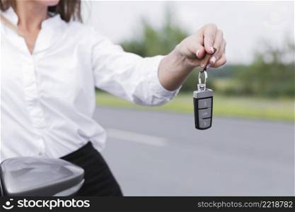 close up woman holding car keys