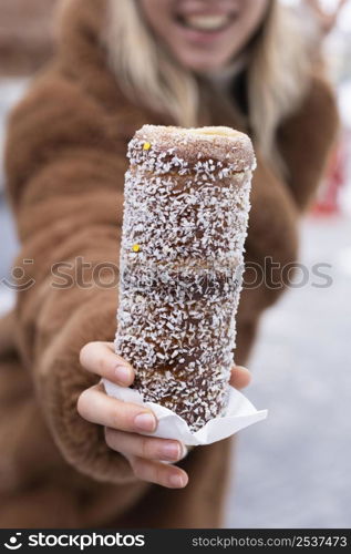 close up woman holding chimney cake