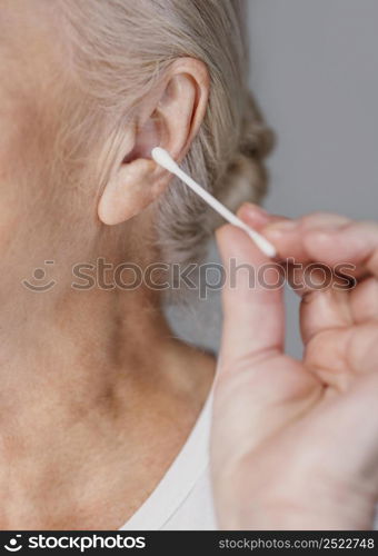 close up woman holding cotton swab