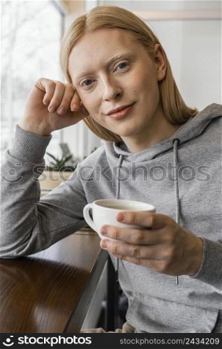 close up woman holding cup 2