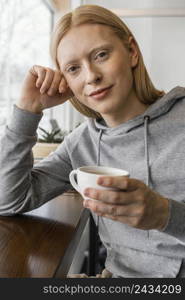 close up woman holding cup 2