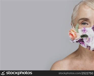 close up woman holding floral mask with copy space